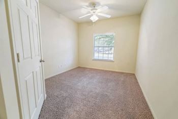 a room with a ceiling fan and a window